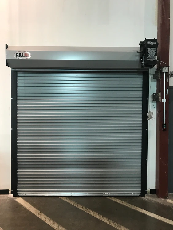 Commercial rolling overhead door with side-mounted operator and control hardware