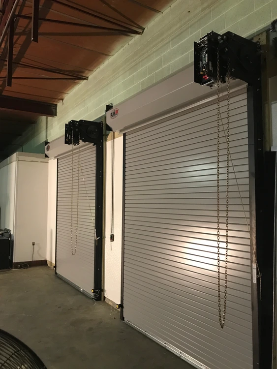 Commercial rolling overhead doors with chain-operated door hardware