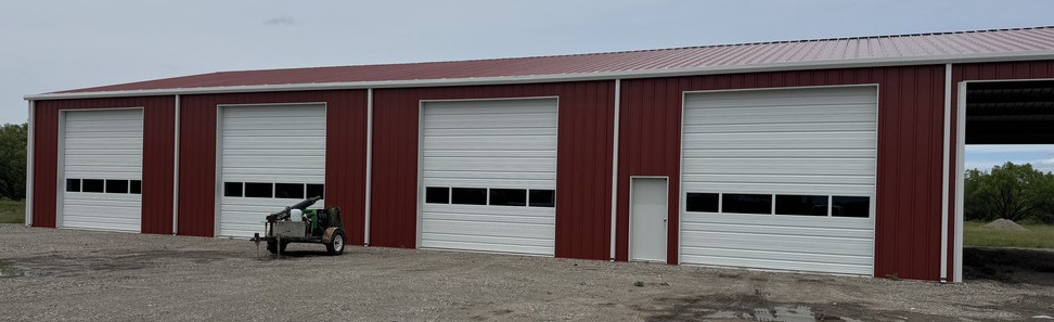 Commercial sectional overhead doors during installation inside a metal building