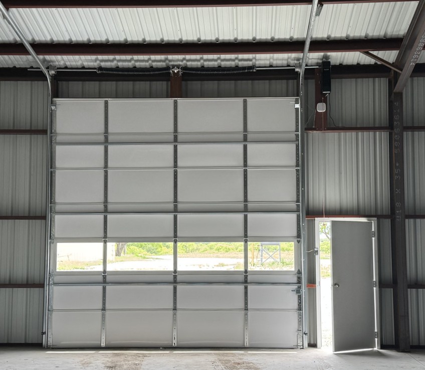 Commercial sectional overhead door system installed inside a metal building
